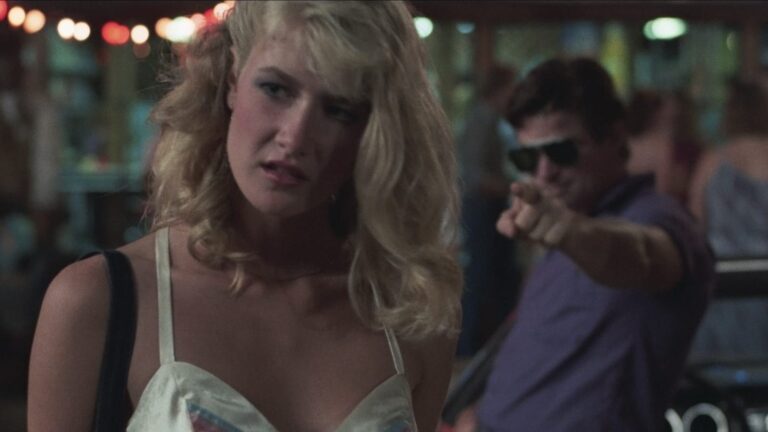 Laura Dern in "Smooth Talk" with a man pointing in the background.