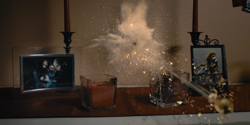 Explosion on a mantelpiece with photos and candles.