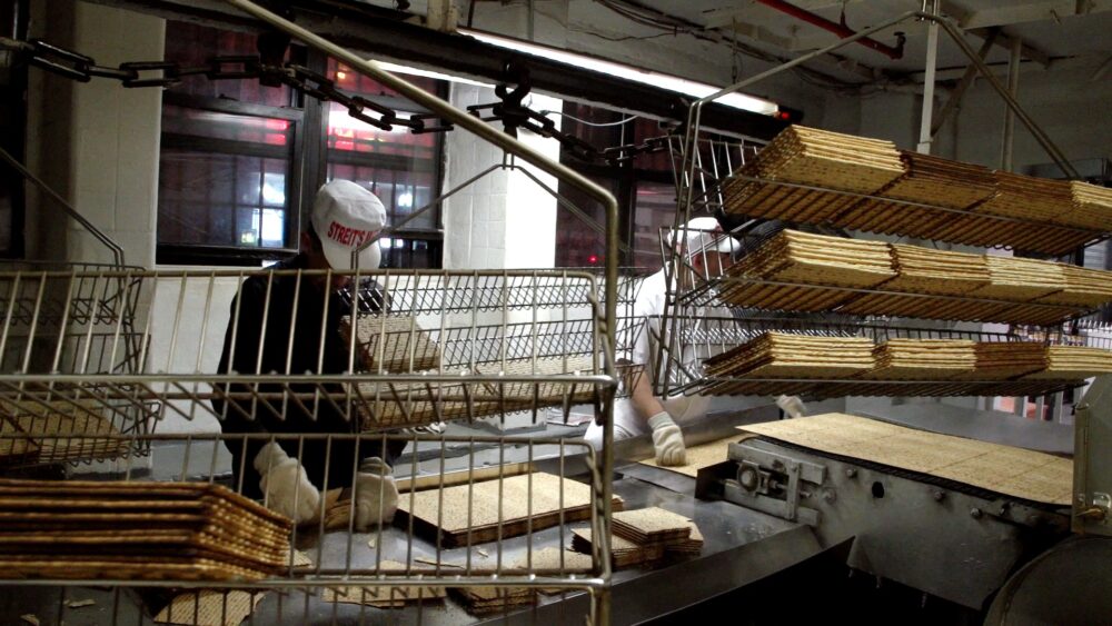 Streit's matzo factory: Workers stacking matzah.
