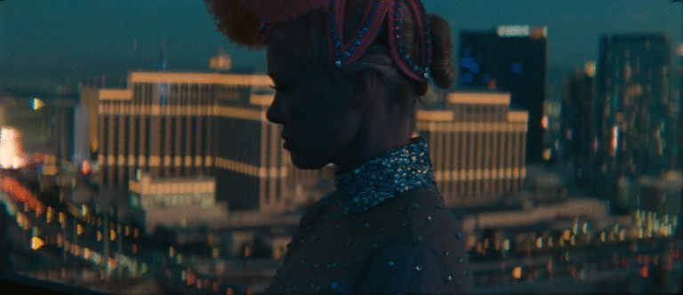 Showgirl silhouette against the Las Vegas skyline at night