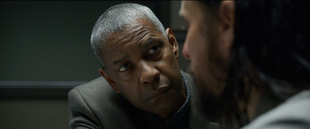 Denzel Washington in "The Little Things," looking intensely at Rami Malek during an interrogation scene.