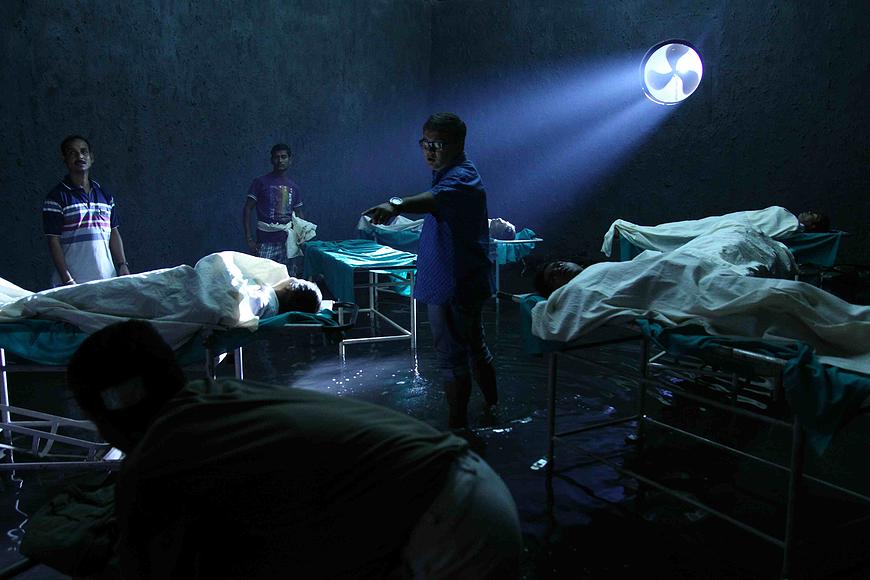 Teenkahon scene: flooded morgue with bodies, men, and dramatic lighting.