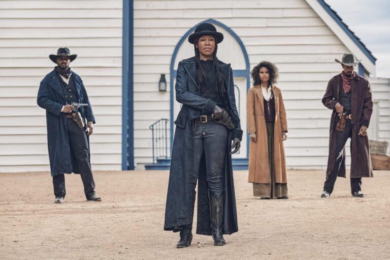 Regina King stars in "The Harder They Fall" with armed cowboys in a Western scene.