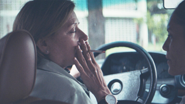 Woman smoking in a car.