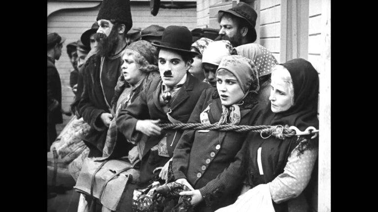 Charlie Chaplin in "The Immigrant" film scene, with fellow passengers on a ship.