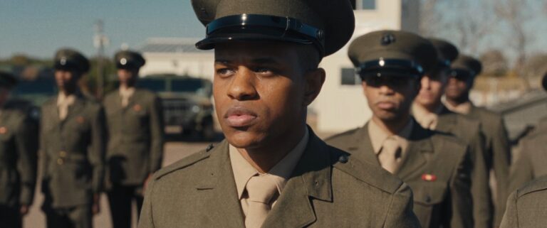 Marines in uniform stand at attention.