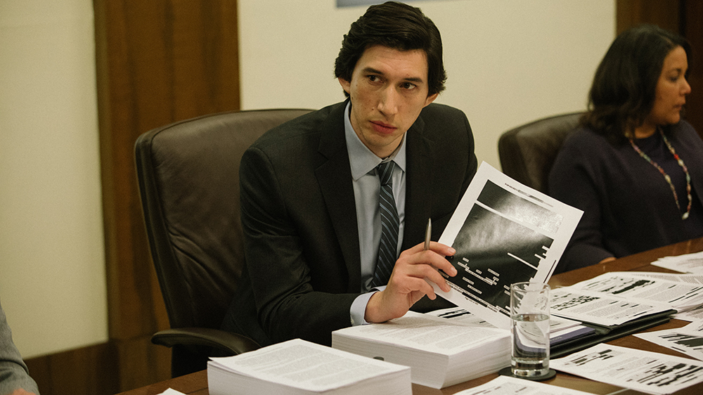 Adam Driver as Daniel Jones in "The Report," reviewing documents.