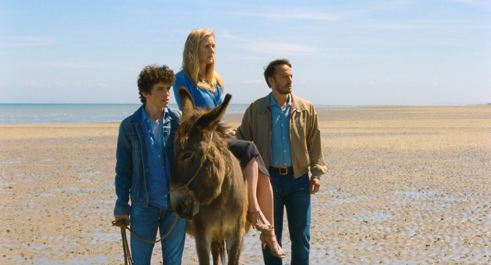Family on beach with donkey from "The Son of Joseph" movie.