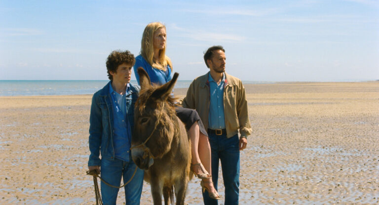 Family on beach with donkey from "The Son of Joseph" movie.