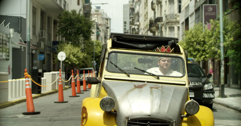 Man driving a quirky yellow car in Buenos Aires street