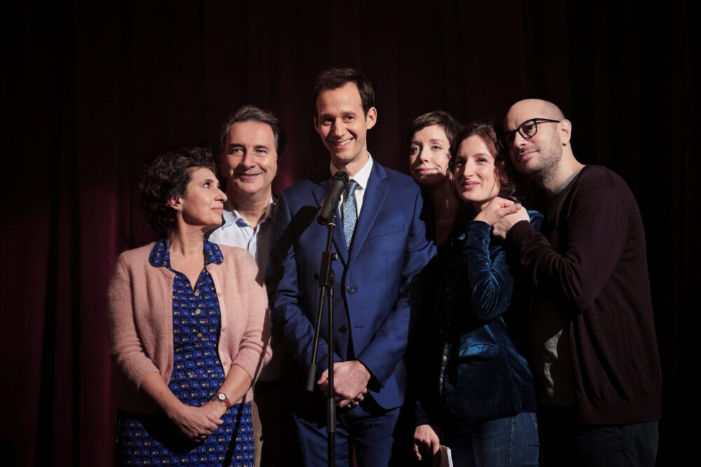 Cast of "The Speech" movie on stage, smiling