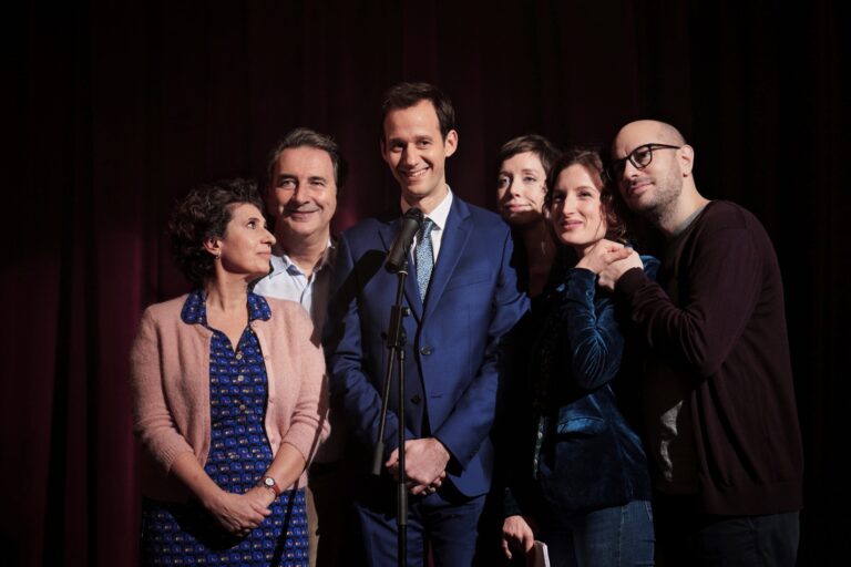 Cast of "The Speech" movie on stage, smiling