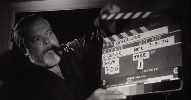Orson Welles with a cigar holding a clapperboard for "Other Wind," dated 3-3-74.