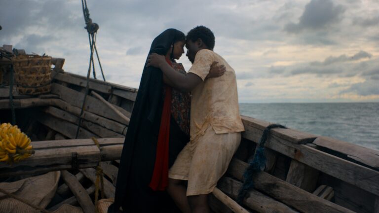 Couple embracing on a weathered boat at sea