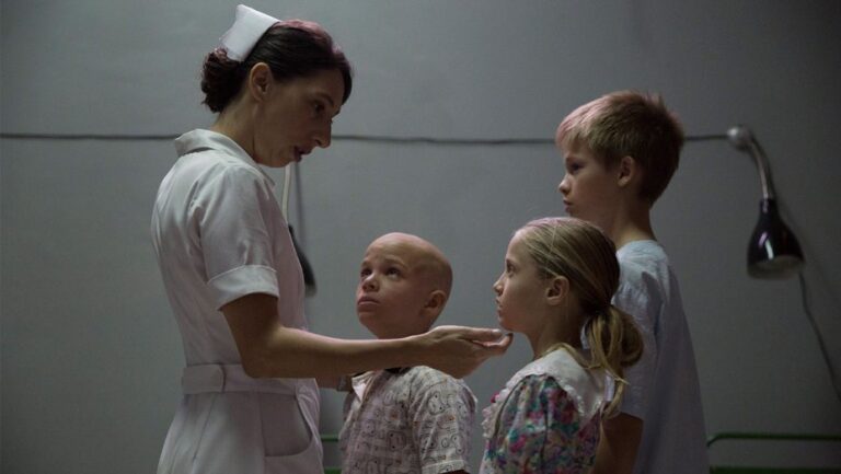Nurse with children in what appears to be a hospital setting.