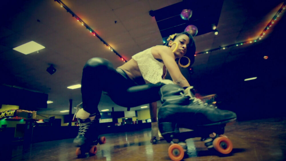 Woman on roller skates at a skating rink.