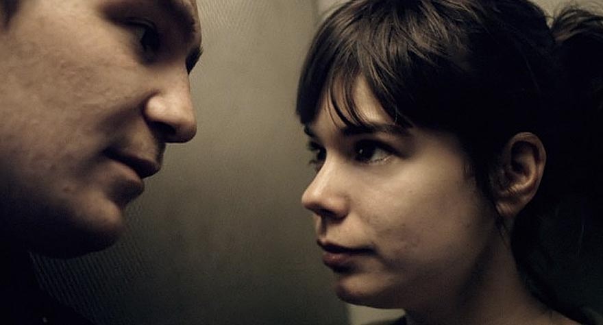 Close-up of a man and woman looking intently at each other.