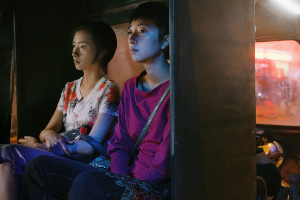 Two people in a tuk-tuk at night, a still from "The Wild Goose Lake.