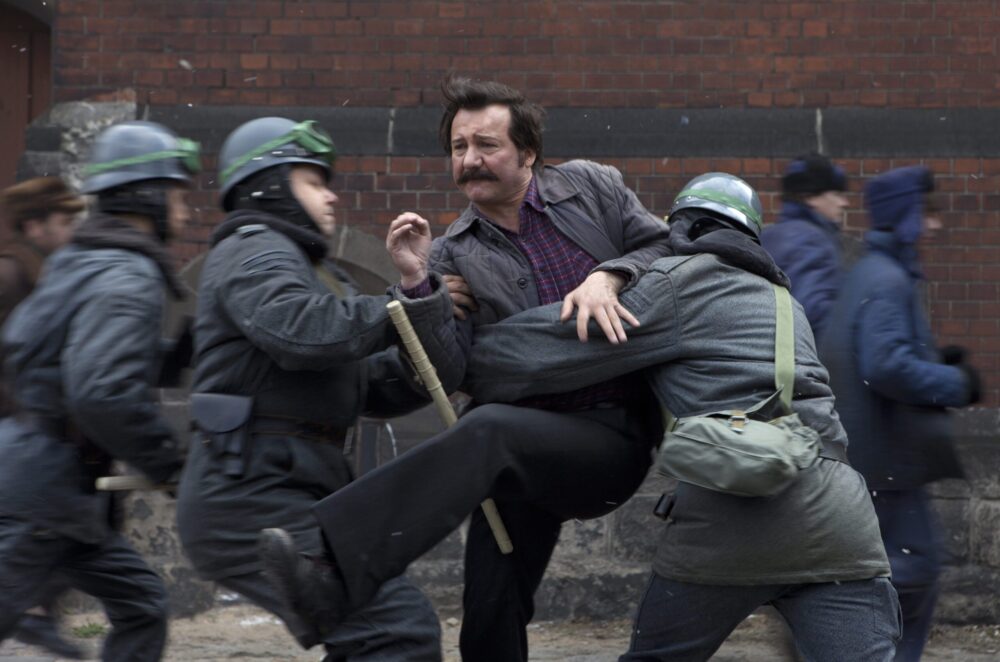Walesa: Man of Hope, captured during a protest, facing riot police.