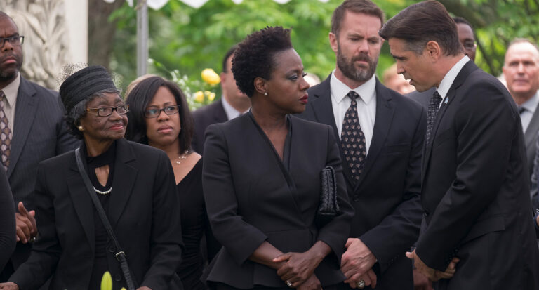 Viola Davis in "Widows" at a somber outdoor gathering.