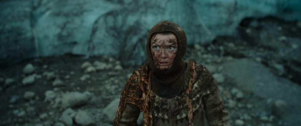 Woman in traditional Icelandic sweater near glacier, from 'Woman at War' film.