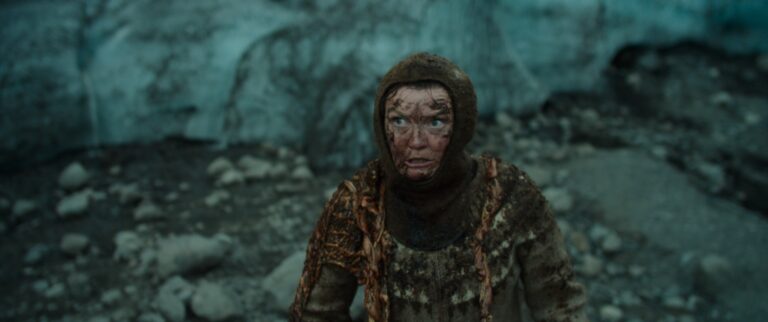 Woman in traditional Icelandic sweater near glacier, from 'Woman at War' film.