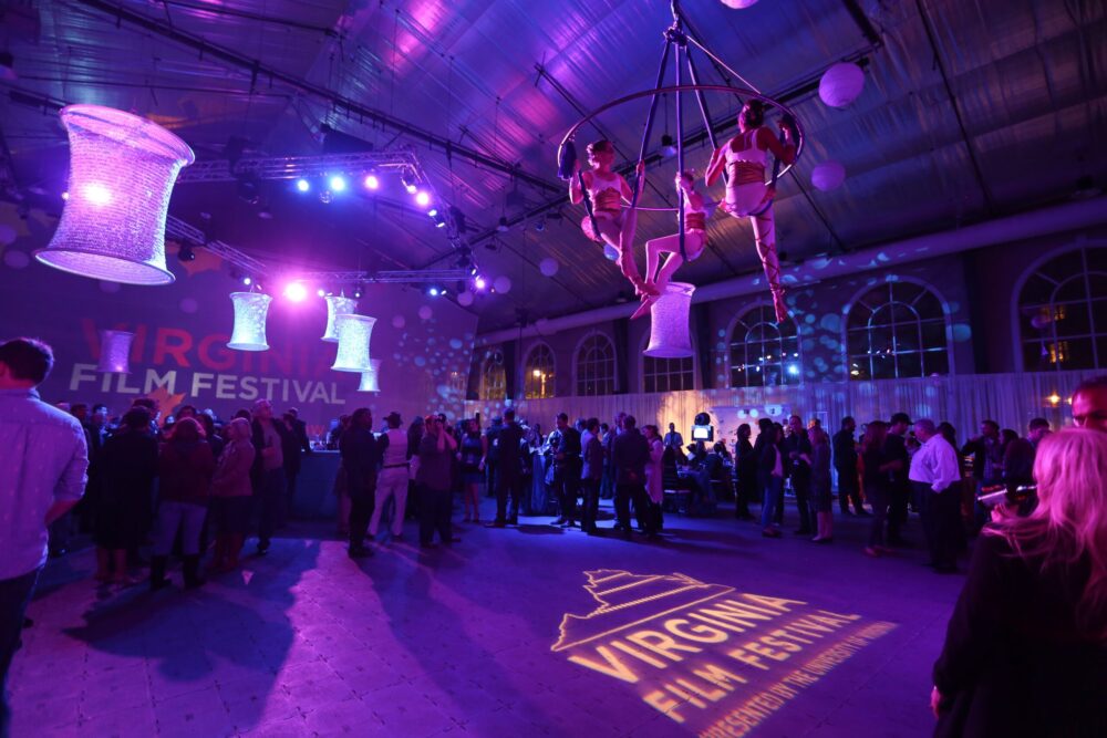 Virginia Film Festival wrap party with aerial performers and large crowd.