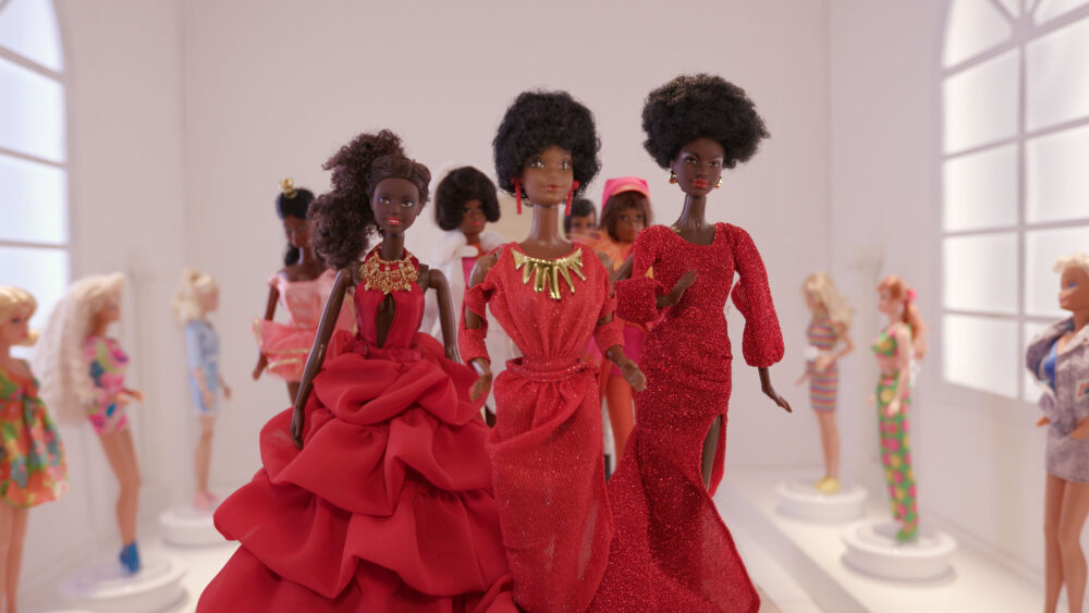 Black Barbie dolls in red gowns, part of the "Black Barbie: a Documentary" collection.