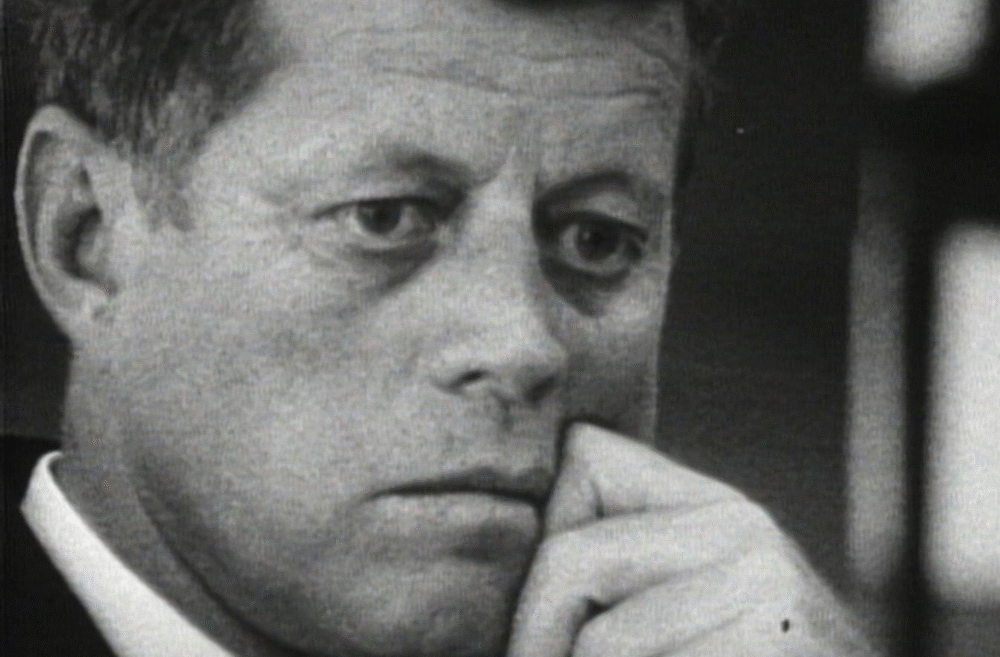 John F. Kennedy in a thoughtful pose, possibly during a crisis.
