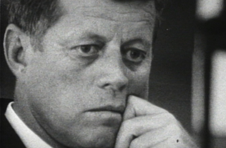 John F. Kennedy in a thoughtful pose, possibly during a crisis.