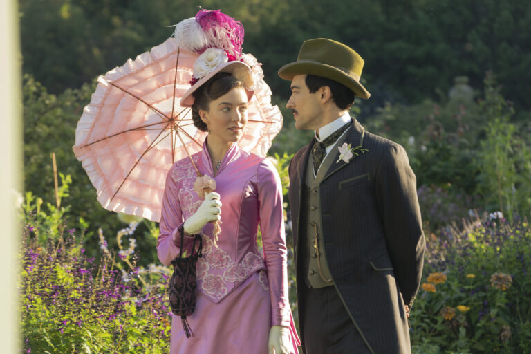 Gilded Age Season 2: Elegant couple in period clothing in a garden.