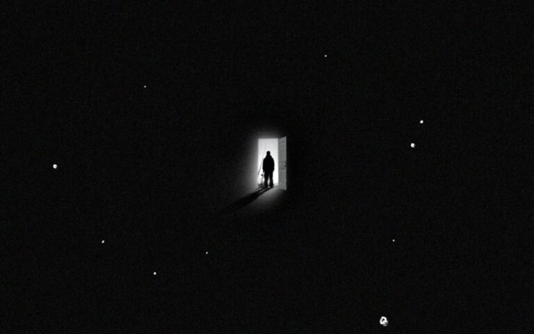 Silhouette of person and dog in doorway, light shining into darkness. Dreams of Home.