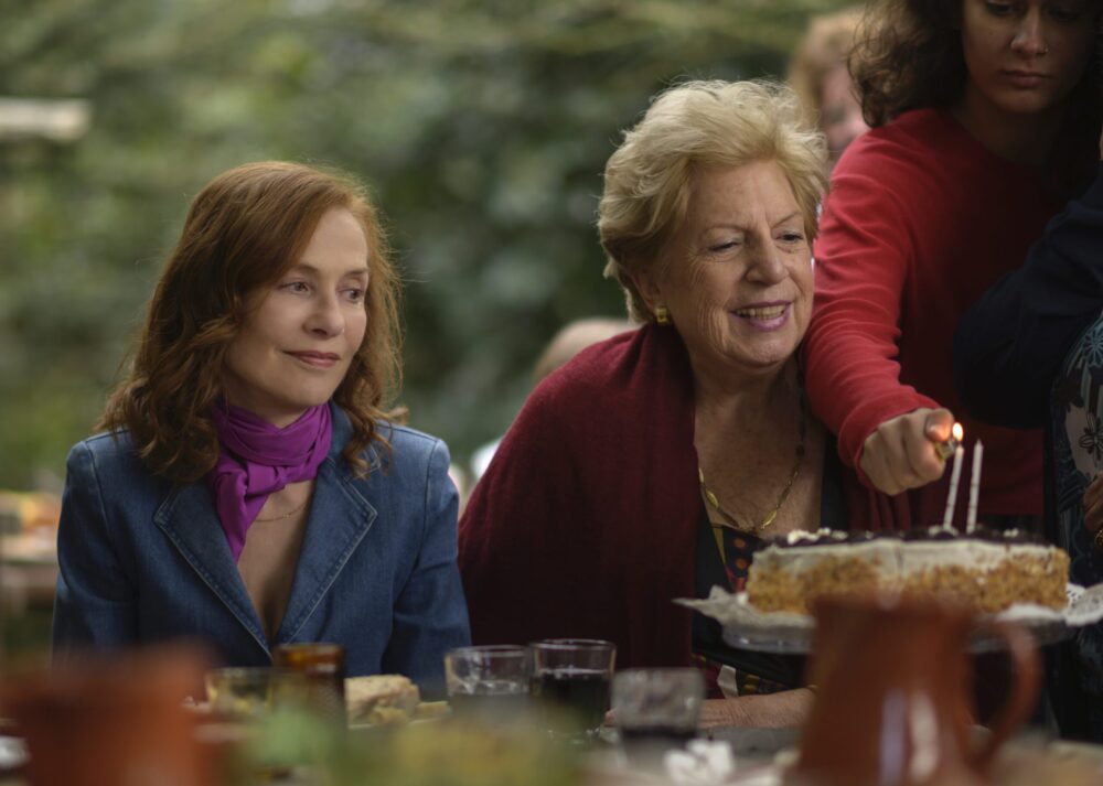 Isabelle Huppert in "Frankie" film, celebrating with family.