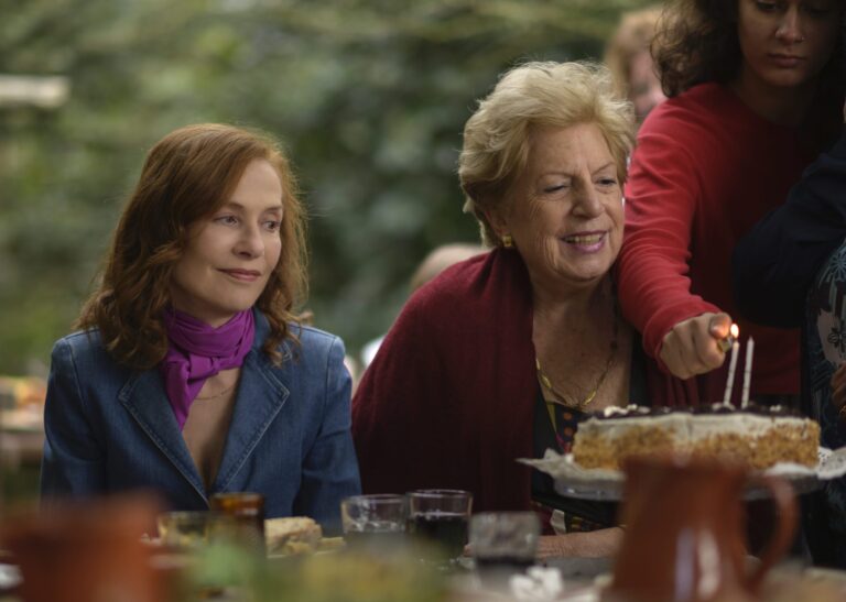 Isabelle Huppert in "Frankie" film, celebrating with family.