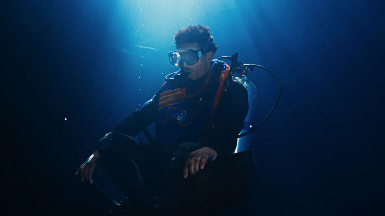 Black scuba diver underwater with gear. Black Godfather of Scuba diving.