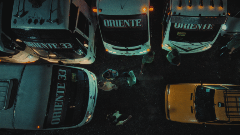 Overhead view of "Oriente" buses and people.