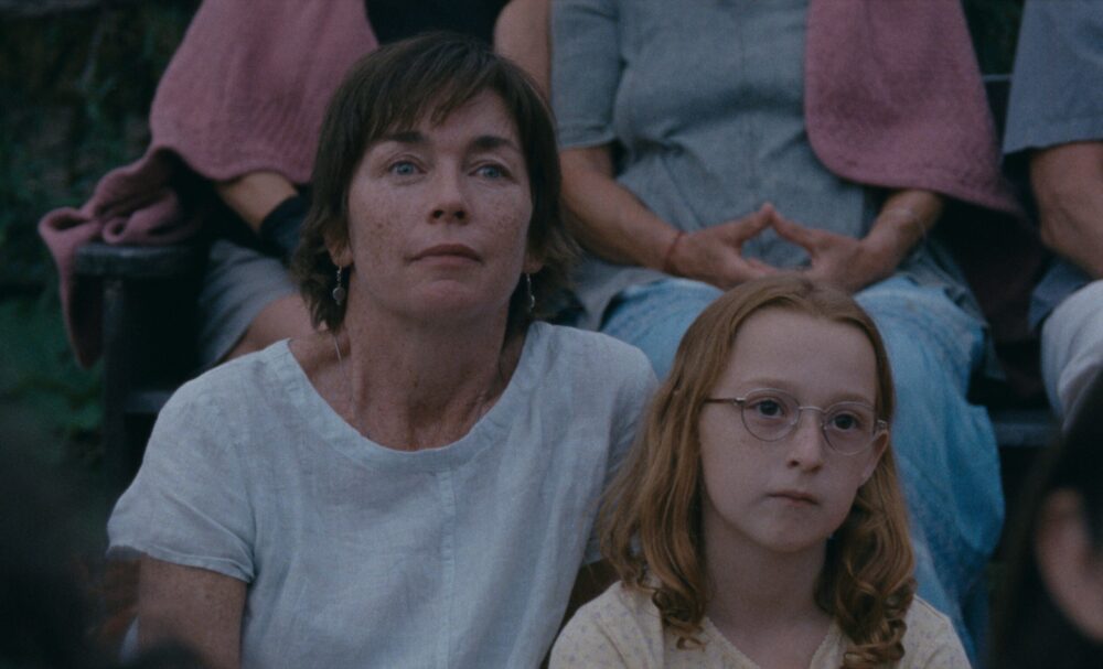 Janet Planet: A woman and child sit together, looking thoughtful.