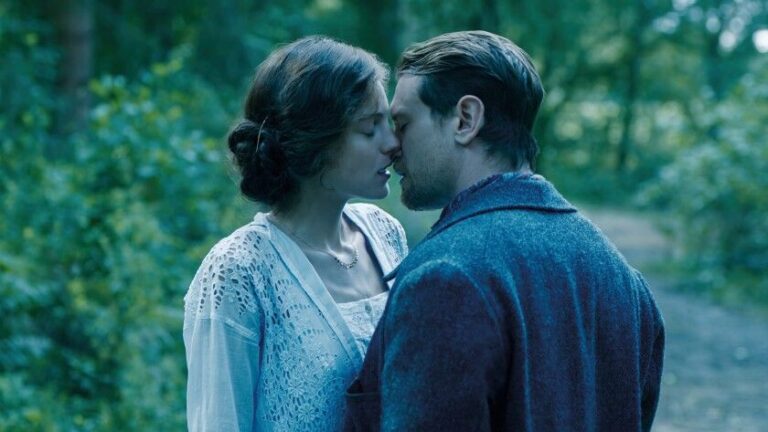 Passionate kiss between Lady Chatterley and her lover in a forest setting.