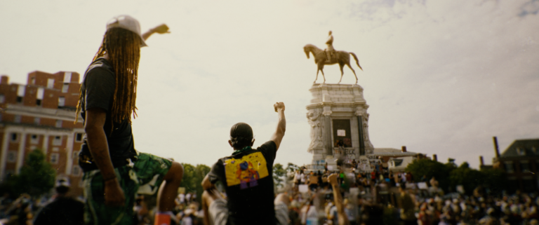Protesters with raised fists in front of the Robert E. Lee monument, Richmond, VA.