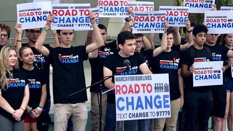 Parkland Rising activists holding "Road to Change" signs at a rally.