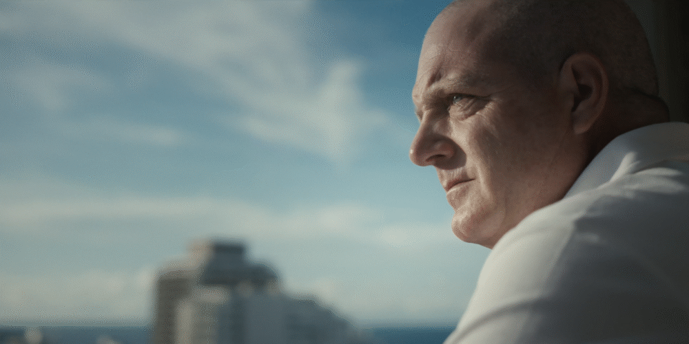 Pensive man looking out at the city skyline.