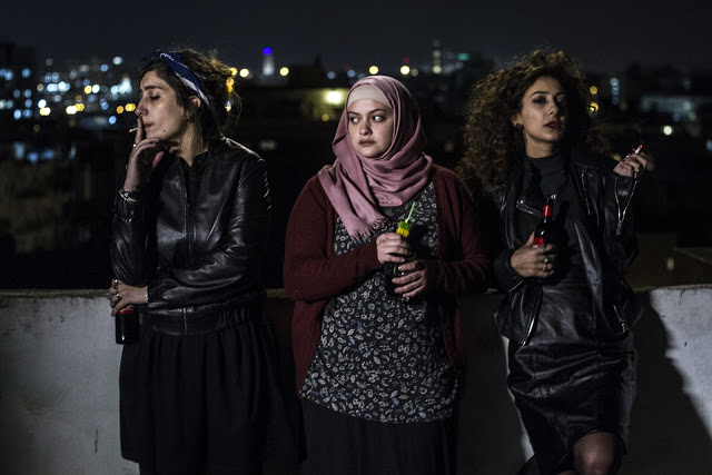 Three women on a rooftop at night, referencing the film In Between.