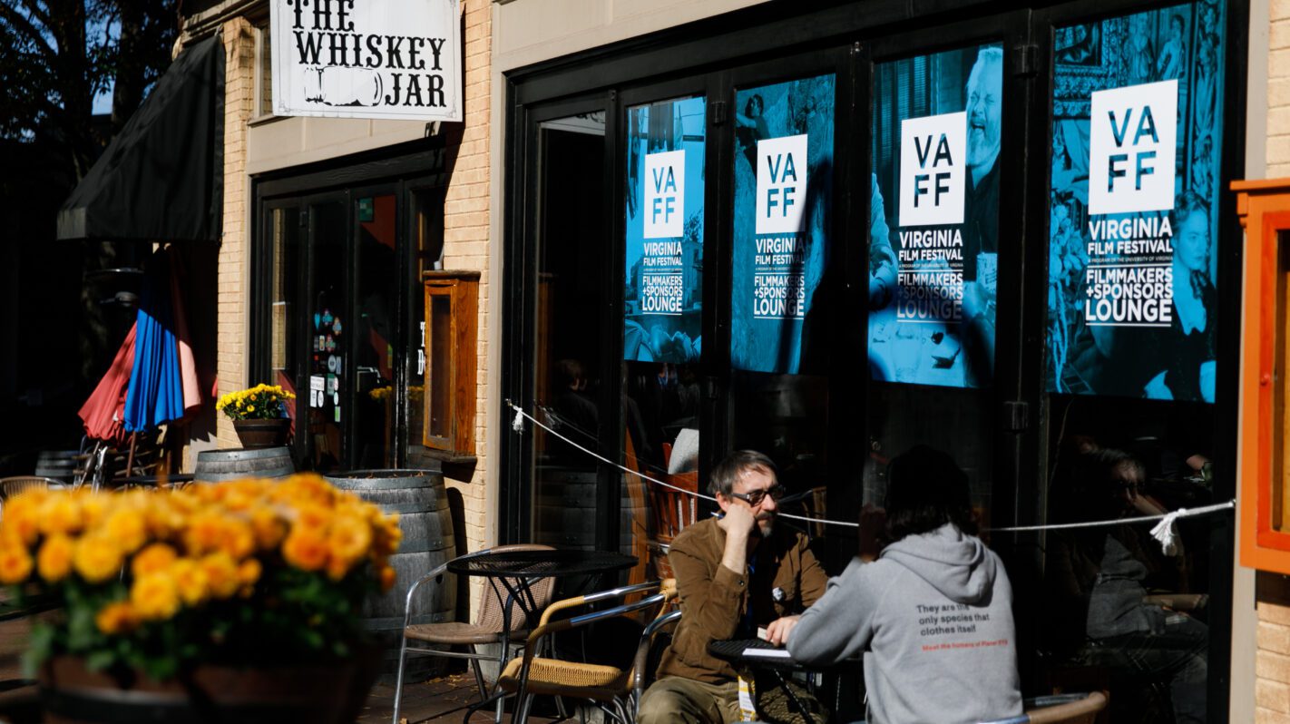 People at The Whiskey Jar outside the Virginia Film Festival Filmmakers Lounge. VAFF posters visible.