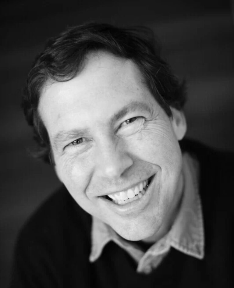 Portrait of Chris Farina smiling warmly at the camera.