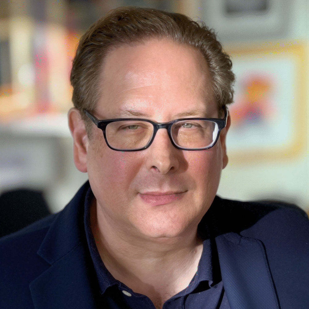 Bill Platt, headshot wearing glasses and a blue jacket.