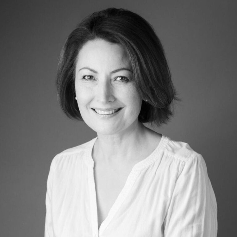 Mineko Mori, a smiling woman with short dark hair, wearing a white blouse.