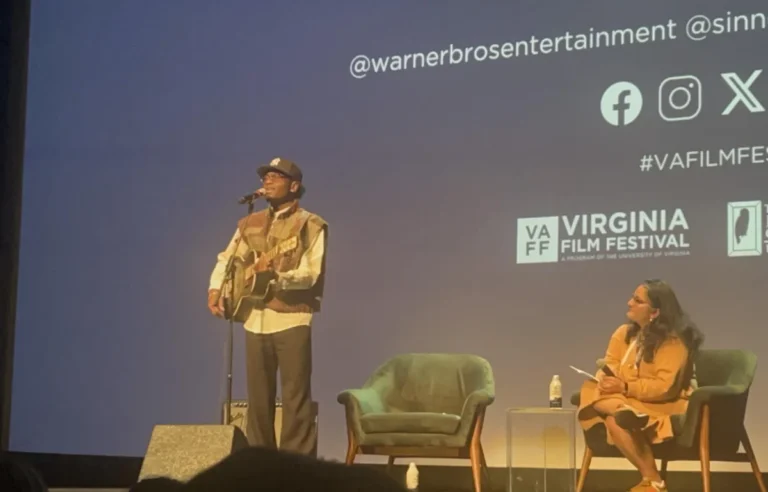 Miles Caton playing guitar after the SINNERS screening while moderator Roxana Hadidi onlooks.