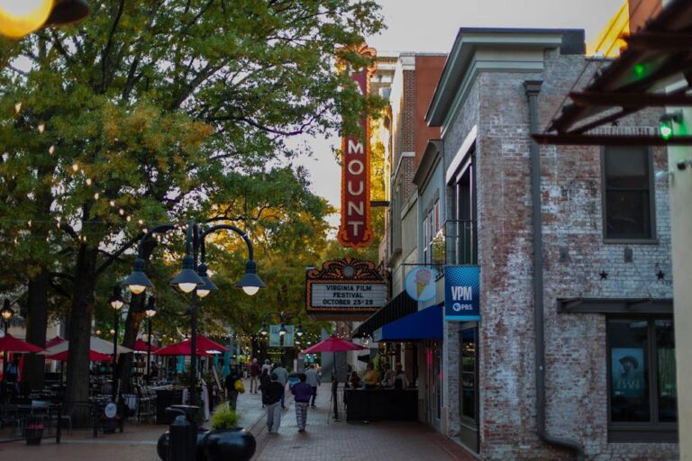 The Paramount Theater marquee during twilight. Passerbys line the street.